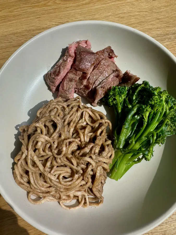 Steak, Miso Noodles and Tenderstem Broccoli shown at a corporate catering event.